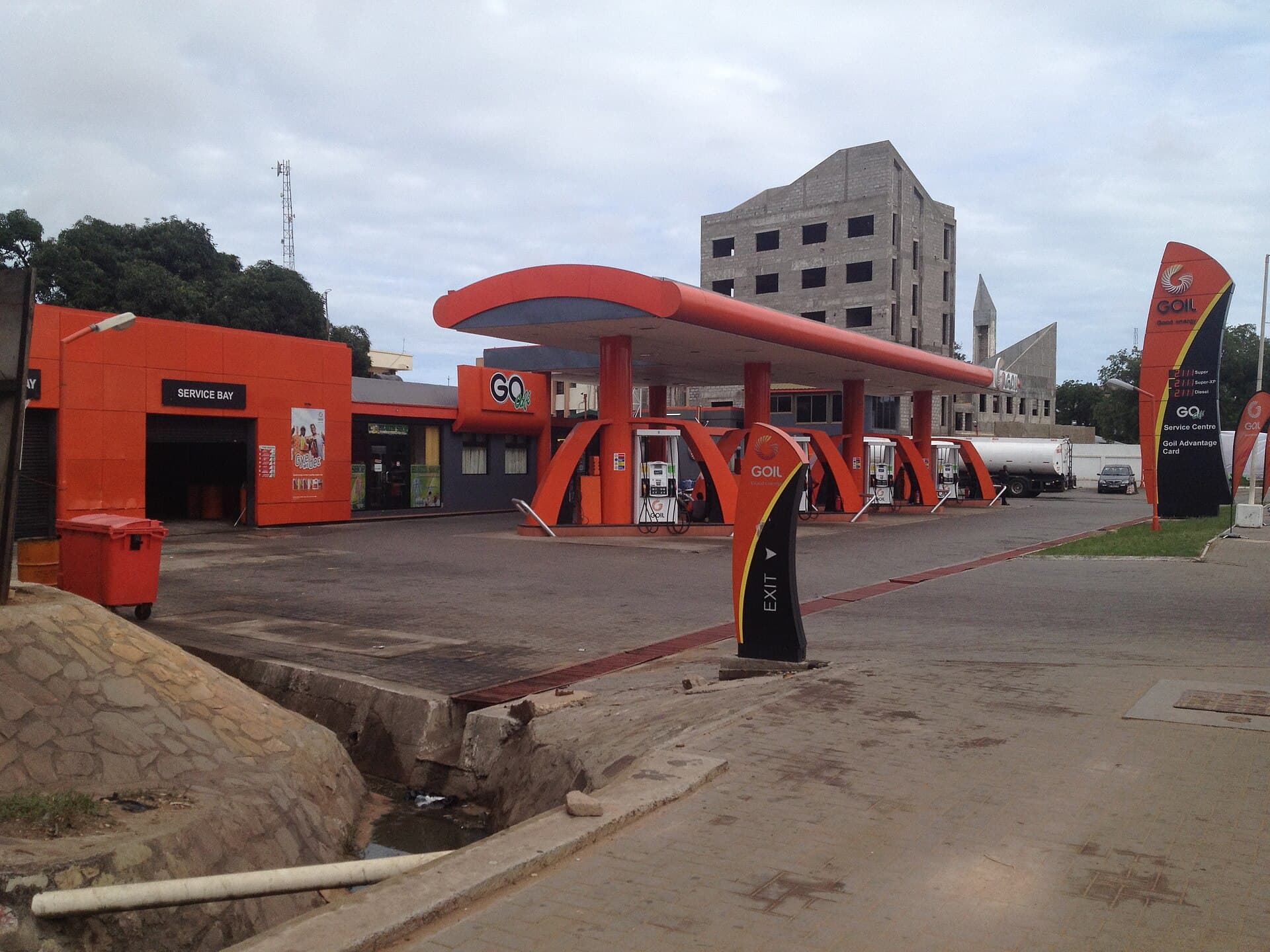 Orange GOIL fuel station forecourt with pumps under a canopy in Ghana