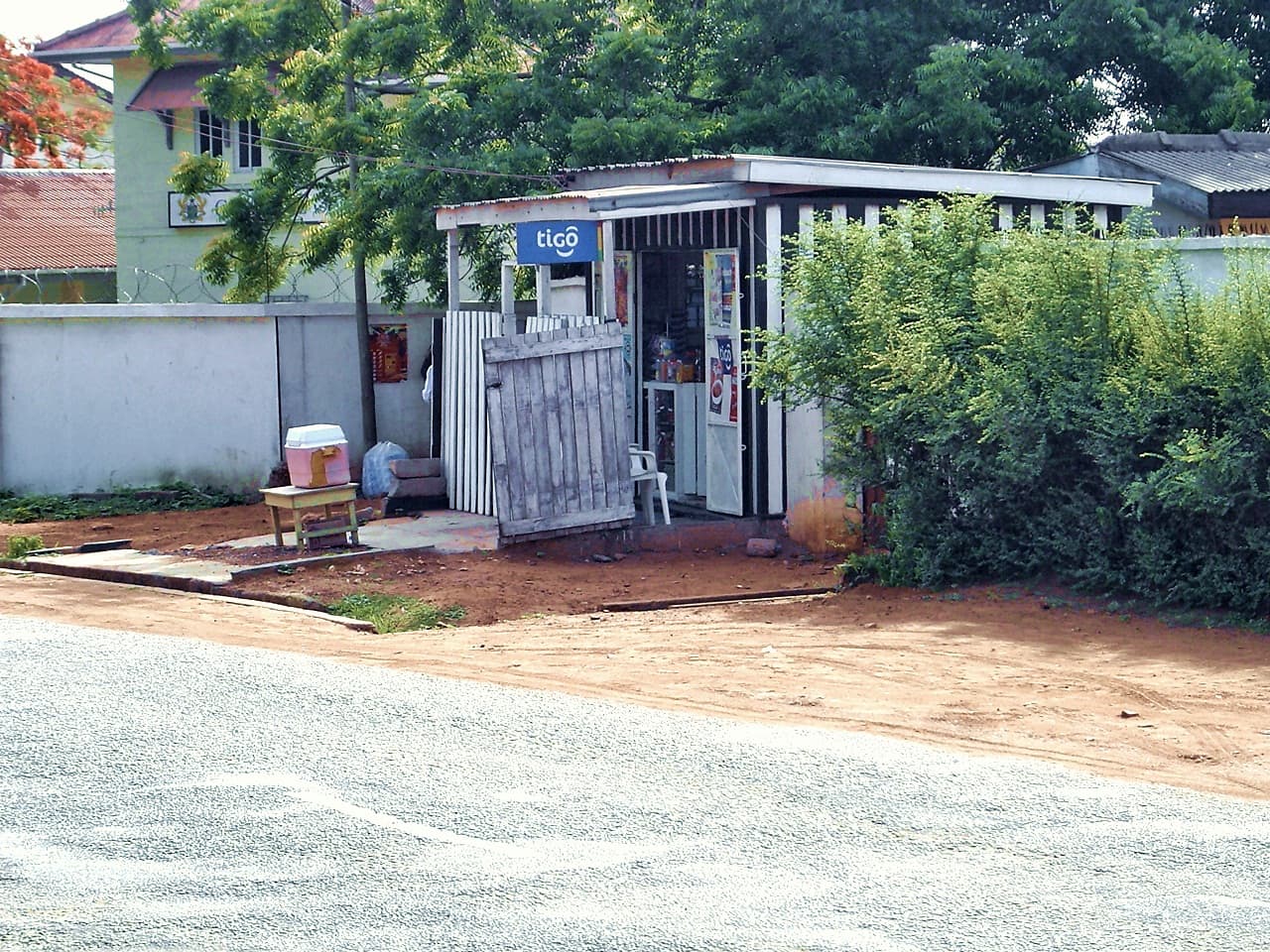 A small roadside mobile phone shop in Accra with a Tigo sign, photographed in 2007